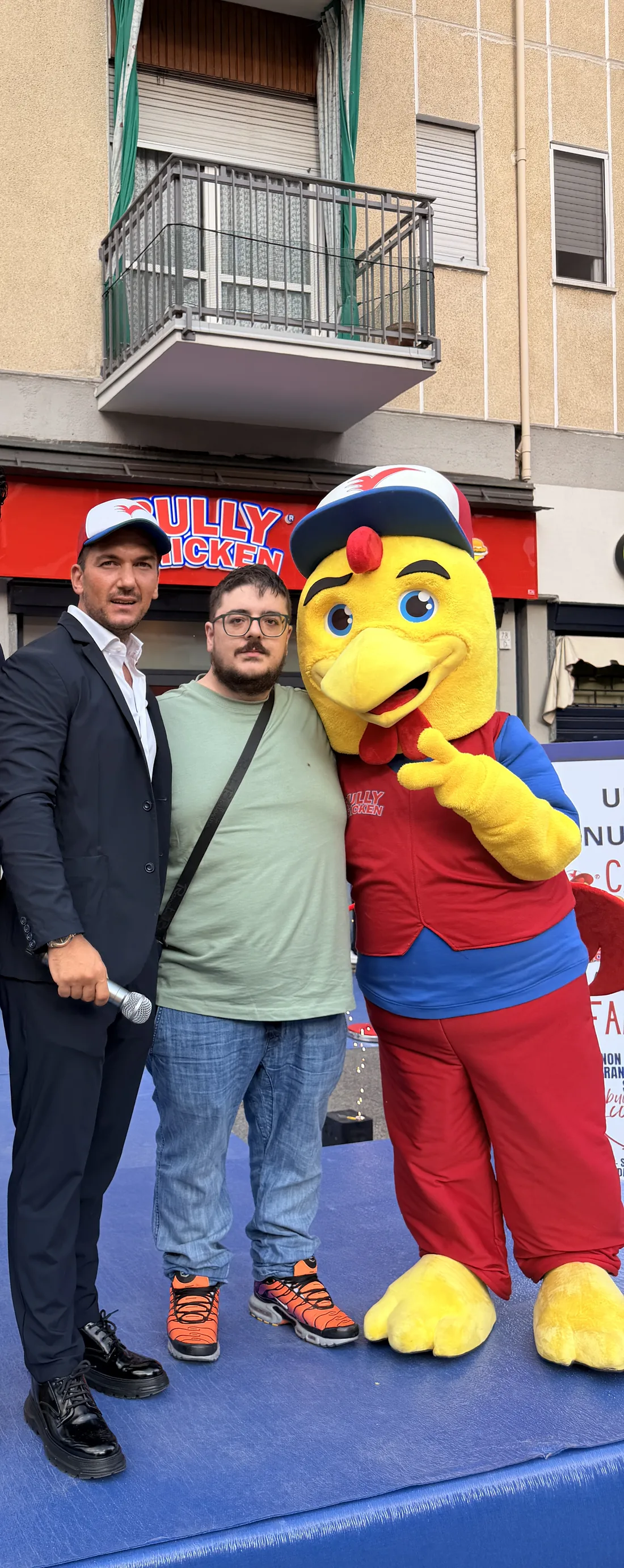 Il presentatore con un ospite e la mascotte Bully Chicken tra le scintille
